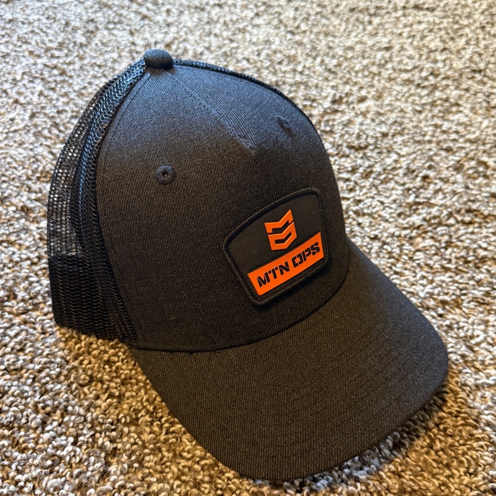 MTN OPS Black and Orange Trucker Hat